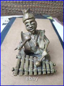 Vintage hand made bronze figurine African man play on xylophone