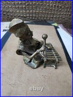 Vintage hand made bronze figurine African man play on xylophone